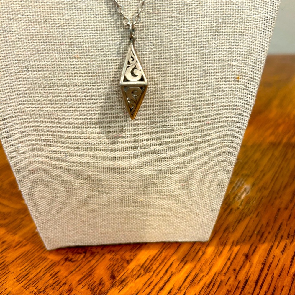Vintage 18 in. Sterling Silver chain with approximately 1 inch scrolled pendant.